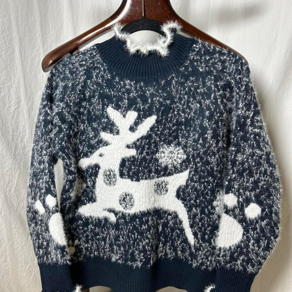 women's navy blue Christmas sweater with‎ a white reindeer and snowflake pattern